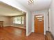 Inviting foyer featuring gleaming hardwood floors, a stone fireplace and front door with sidelights at 4324 Garland Dr, Raleigh, NC 27606