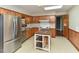 Functional kitchen with wooden cabinets, island prep, and stainless steel refrigerator at 4324 Garland Dr, Raleigh, NC 27606
