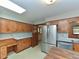Kitchen featuring wood cabinets, stainless steel fridge, and island workstation, with sun roof at 4324 Garland Dr, Raleigh, NC 27606