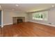 Bright living room with hardwood floors, a stone fireplace, and large windows at 4324 Garland Dr, Raleigh, NC 27606