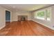 Cozy living room showcasing a traditional brick fireplace and hardwood flooring throughout at 4324 Garland Dr, Raleigh, NC 27606