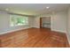 Spacious living room featuring gleaming hardwood floors and natural light from a large window at 4324 Garland Dr, Raleigh, NC 27606