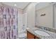 Bathroom features a sink with granite counter and tub with a colorful curtain at 449 Christian Creek Pl, Cary, NC 27519