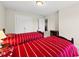 Bedroom featuring two beds with red striped bedding and access to closet at 449 Christian Creek Pl, Cary, NC 27519