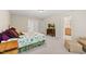 Bright bedroom with a TV on dresser, cozy chair, and comfortable floral bed; light and airy at 449 Christian Creek Pl, Cary, NC 27519