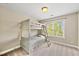 Bedroom with white bunk beds with built-in storage underneath and a view of nature outside the window at 449 Christian Creek Pl, Cary, NC 27519