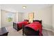 Bedroom featuring two beds with red striped bedding and a large window at 449 Christian Creek Pl, Cary, NC 27519