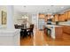 Open dining and kitchen area featuring stainless appliances, hardwood floors and a staircase leading upstairs at 449 Christian Creek Pl, Cary, NC 27519