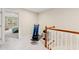 Upstairs hallway featuring carpet and a stairway with wood railing leading to a bedroom at 449 Christian Creek Pl, Cary, NC 27519