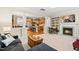 Open-concept living room and kitchen, featuring a fireplace, a breakfast bar, and hardwood floors at 449 Christian Creek Pl, Cary, NC 27519