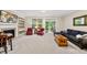 Cozy living room featuring a fireplace with a TV, comfortable seating, and access to a screened-in porch at 449 Christian Creek Pl, Cary, NC 27519