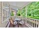 Cozy screened porch with table and chairs overlooking a lush, green backyard at 449 Christian Creek Pl, Cary, NC 27519