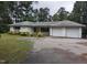 A bright, single-story ranch home features an attached two-car garage and a long asphalt driveway at 4511 Hopson Rd, Morrisville, NC 27560