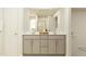Bathroom featuring double sinks, a large mirror, and neutral tones, creating a serene space at 576 Roy Adams Ct, Angier, NC 27501