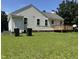 Backyard features a deck, well-maintained lawn, and white siding, complemented by a brick foundation at 6 Boxley Dr, Wendell, NC 27591