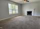 Spacious living room featuring neutral paint, ceiling fan, large window and a fireplace at 6 Boxley Dr, Wendell, NC 27591