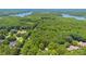 Aerial view showcasing the neighborhood setting with lush trees and a serene lake backdrop at 6701 Green Hollow Ct, Wake Forest, NC 27587