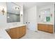 Bright bathroom boasts dual vanities with marble counters, modern fixtures and stylish lighting at 6701 Green Hollow Ct, Wake Forest, NC 27587