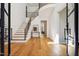 Bright foyer boasts hardwood floors, staircase with black railings, and modern design at 6701 Green Hollow Ct, Wake Forest, NC 27587