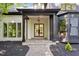 Grand entrance with stone steps, a modern black framed door, and stylish lighting fixture at 6701 Green Hollow Ct, Wake Forest, NC 27587