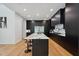 Contemporary kitchen with island seating, modern black cabinets, and chef-grade appliances at 6701 Green Hollow Ct, Wake Forest, NC 27587
