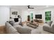 Relaxing living room with comfortable sectional couch, tv screen and hardwood floors at 6701 Green Hollow Ct, Wake Forest, NC 27587