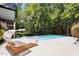 Relaxing lounge area with an in-ground pool and spa, perfect for unwinding at 6701 Green Hollow Ct, Wake Forest, NC 27587