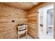 Wood sauna features a wood-burning heater, built-in bench, and glass door to a massage room at 6701 Green Hollow Ct, Wake Forest, NC 27587