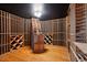 Custom wine cellar with wooden racks, ample storage, and elegant lighting for the wine enthusiast at 6701 Green Hollow Ct, Wake Forest, NC 27587