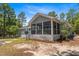 Rear view of a charming home, highlighting the screened-in porch with ceiling fan at 74 Dove Trl Trl, Sanford, NC 27332