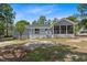 Exterior view of a home with a spacious screened-in back porch and an open deck at 74 Dove Trl Trl, Sanford, NC 27332