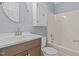 Well-lit bathroom with white cabinets, modern sink, and bathtub-shower combo with light blue walls at 74 Dove Trl Trl, Sanford, NC 27332