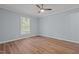 This bedroom features light blue walls, wood floors, a ceiling fan, and a window at 74 Dove Trl Trl, Sanford, NC 27332