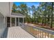View from the deck, showcasing the screened porch and wooded backyard at 74 Dove Trl Trl, Sanford, NC 27332