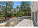 Overlooking the spacious yard with a view of lush trees from a wooden deck at 74 Dove Trl Trl, Sanford, NC 27332