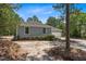 Side view of the house with a two-car garage and gravel driveway at 74 Dove Trl Trl, Sanford, NC 27332