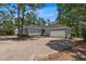 Charming single-story home featuring a two-car garage and a gravel driveway at 74 Dove Trl Trl, Sanford, NC 27332