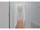This hallway has light blue walls and wood floors at 74 Dove Trl Trl, Sanford, NC 27332