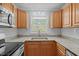 Updated kitchen with stainless appliances, granite counters, a modern sink and tile backsplash at 74 Dove Trl Trl, Sanford, NC 27332