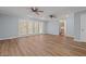 This open-concept living room has light blue walls, wood floors, and sliding glass doors to the outside at 74 Dove Trl Trl, Sanford, NC 27332