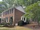 Brick two-story home with black shutters, a bay window, and a fenced yard at 7905 Breda Ct, Raleigh, NC 27606