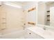 Bathroom features a shower-tub combo with built-in shelves, single vanity, and large mirror at 906 Stuart Dr, Mebane, NC 27302