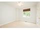 Neutral bedroom with carpet, ceiling fan, and a window with woven shades offers a serene retreat at 906 Stuart Dr, Mebane, NC 27302