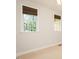 Neutral bedroom with carpet and a window with woven shades, offers a serene retreat at 906 Stuart Dr, Mebane, NC 27302