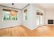 Bright living room boasts hardwood floors, a fireplace, French doors to the outside, and woven shade window coverings at 906 Stuart Dr, Mebane, NC 27302
