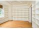 Spacious office features hardwood floors, a large window, and built-in bookshelves for ample storage at 906 Stuart Dr, Mebane, NC 27302