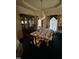 Elegant dining room with a crystal chandelier, china cabinet, and floral tablecloth at 9160 Old Cascade Road Dr, Garner, NC 27529
