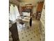 A dining room with a table and floral wallpaper offers a charming, traditional space at 9160 Old Cascade Road Dr, Garner, NC 27529