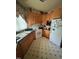 A corner kitchen with light wood cabinets, and white appliances offers a functional space at 9160 Old Cascade Road Dr, Garner, NC 27529