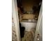 A compact laundry room with white appliances and shelving offers efficiency in a small space at 9160 Old Cascade Road Dr, Garner, NC 27529